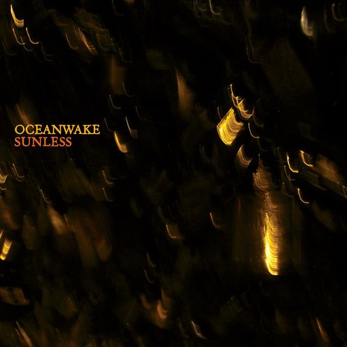 Dark album cover with blurred golden lights and "Oceanwake Sunless" text.