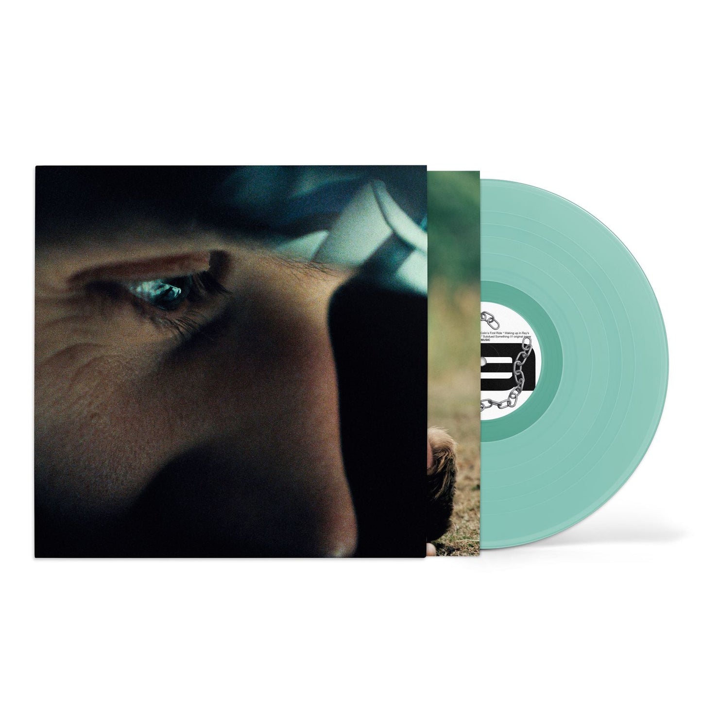 Vinyl record cover featuring a close-up of an eye beside a mint green disc.