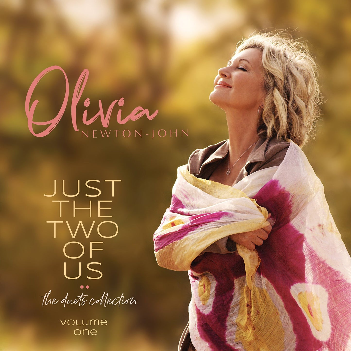 "Olivia Newton-John album cover featuring her portrait with a shawl, outdoors."