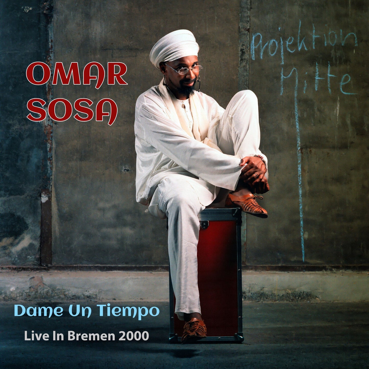 Omar Sosa album cover: man in white sitting on a case.