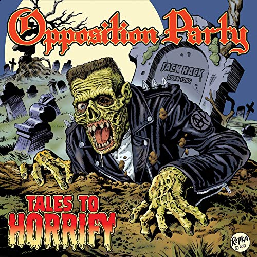 A zombie in a leather jacket crawls out of a grave in a cemetery.