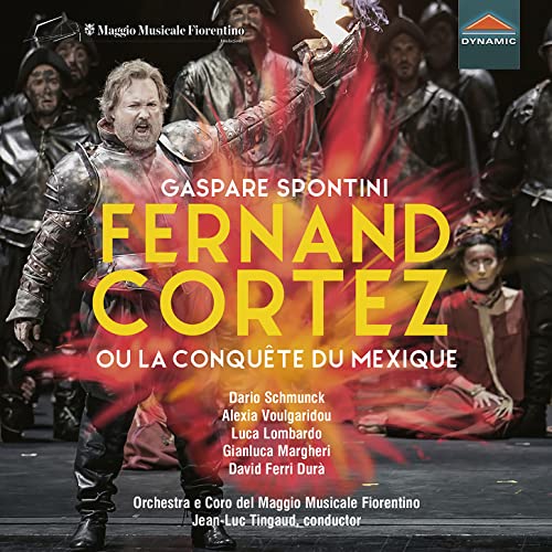 CD cover featuring a male singer in armor amidst a theatrical production with fire.
