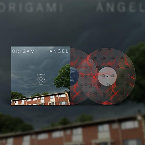 Vinyl record with red splatter effect, album cover showing a building.