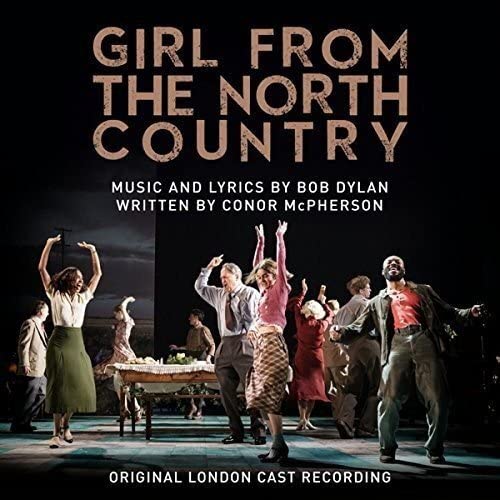 Cast performing on stage under "Girl From The North Country" title, dark background.