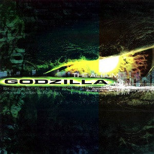 Godzilla" album cover: dark green and yellow tones, city silhouette, Godzilla’s face.