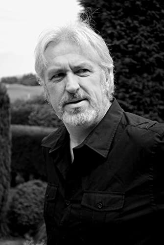 Black and white portrait of a gray-haired man with a beard.