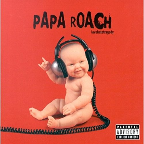 A baby wearing headphones makes a rock hand sign against a solid red background.