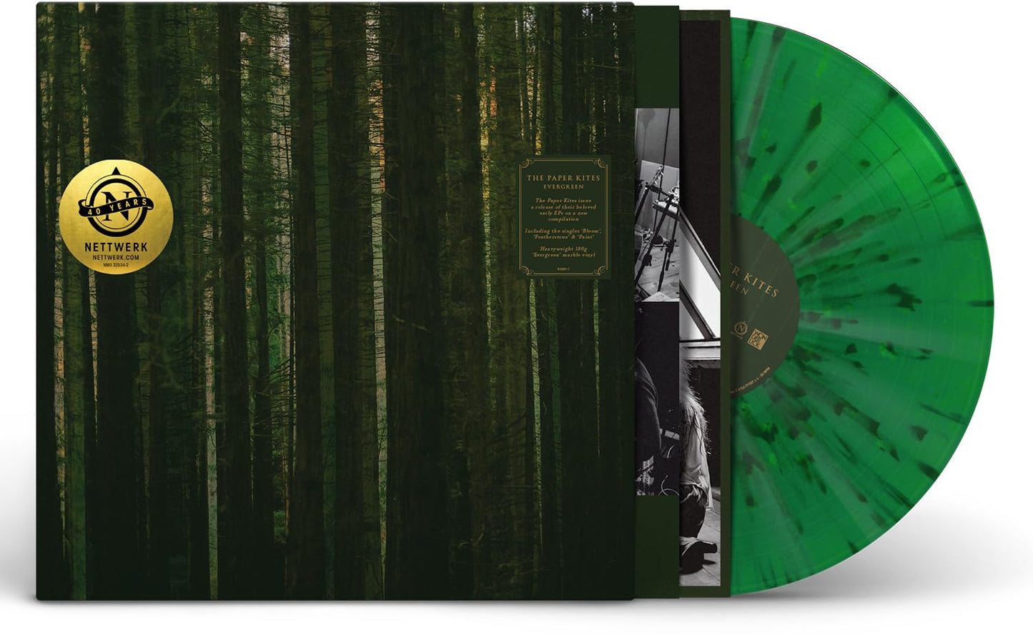 Green and black marbled vinyl record with forest imagery and band logo.