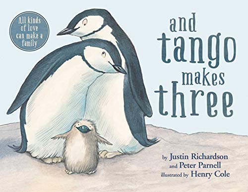 Two adult penguins standing behind a small fluffy chick on a light blue background.