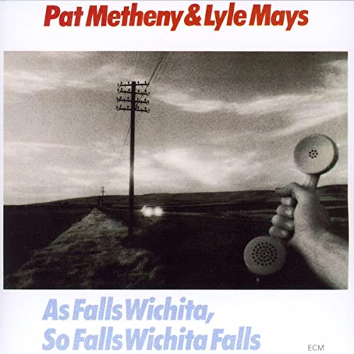 Album cover featuring a hand holding a telephone receiver against a rural landscape.