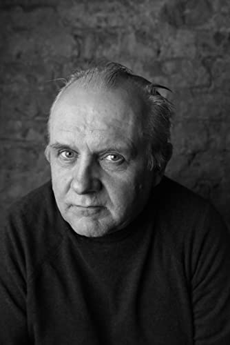 Black and white portrait of an older man with thinning hair.