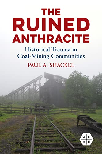 Book cover with a ruined coal mine structure in a misty landscape.