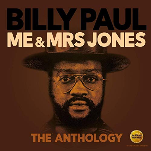 Billy Paul wearing a hat and glasses on a brown background album cover.