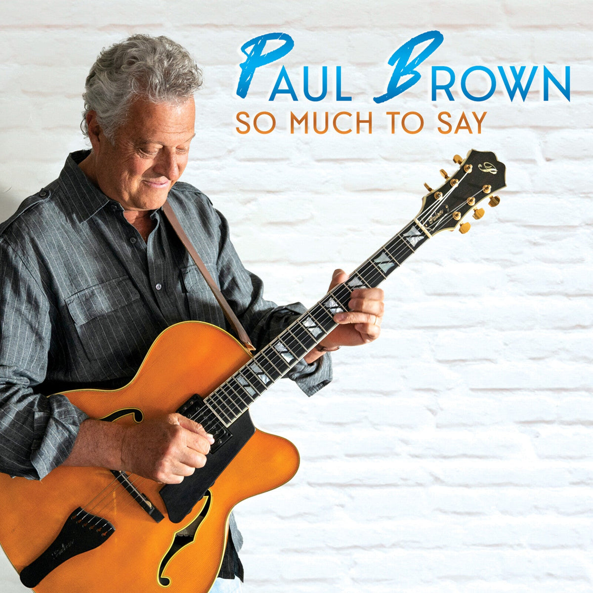 Paul Brown with a guitar, album cover for “So Much To Say.”