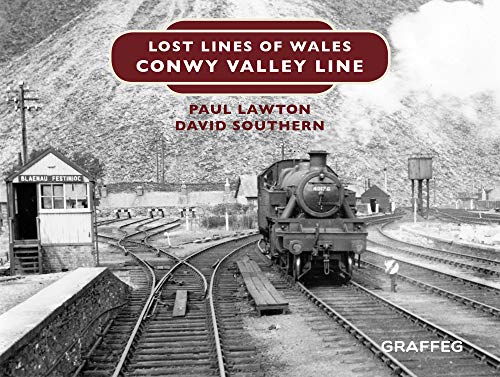 Black and white photo of a steam train on railway tracks in Wales.