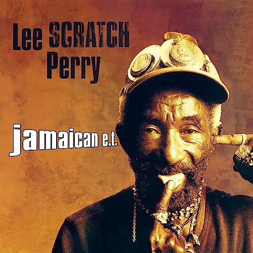 Lee "Scratch" Perry portrait with goggles and jewelry, album cover.