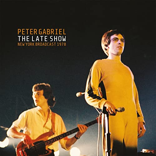 Peter Gabriel album cover featuring a man in a yellow jumpsuit onstage.