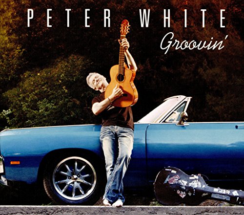 Peter White album cover, man with guitar by a blue car.