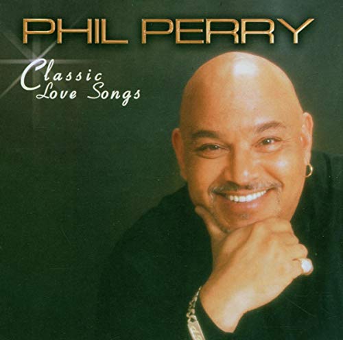 Phil Perry smiling with his hand on his chin on a dark green background.