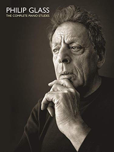 Black and white portrait of composer Philip Glass, hand to chin.