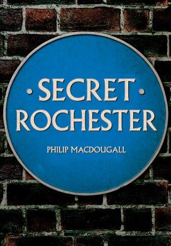 Blue circular sign reading "Secret Rochester" against a brick wall.