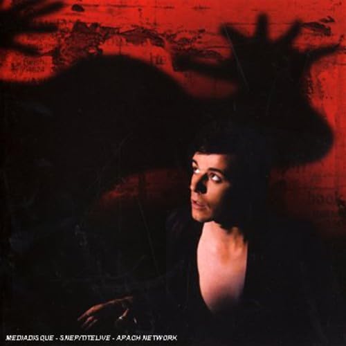 CD cover: man’s profile in shadow against a textured red background.