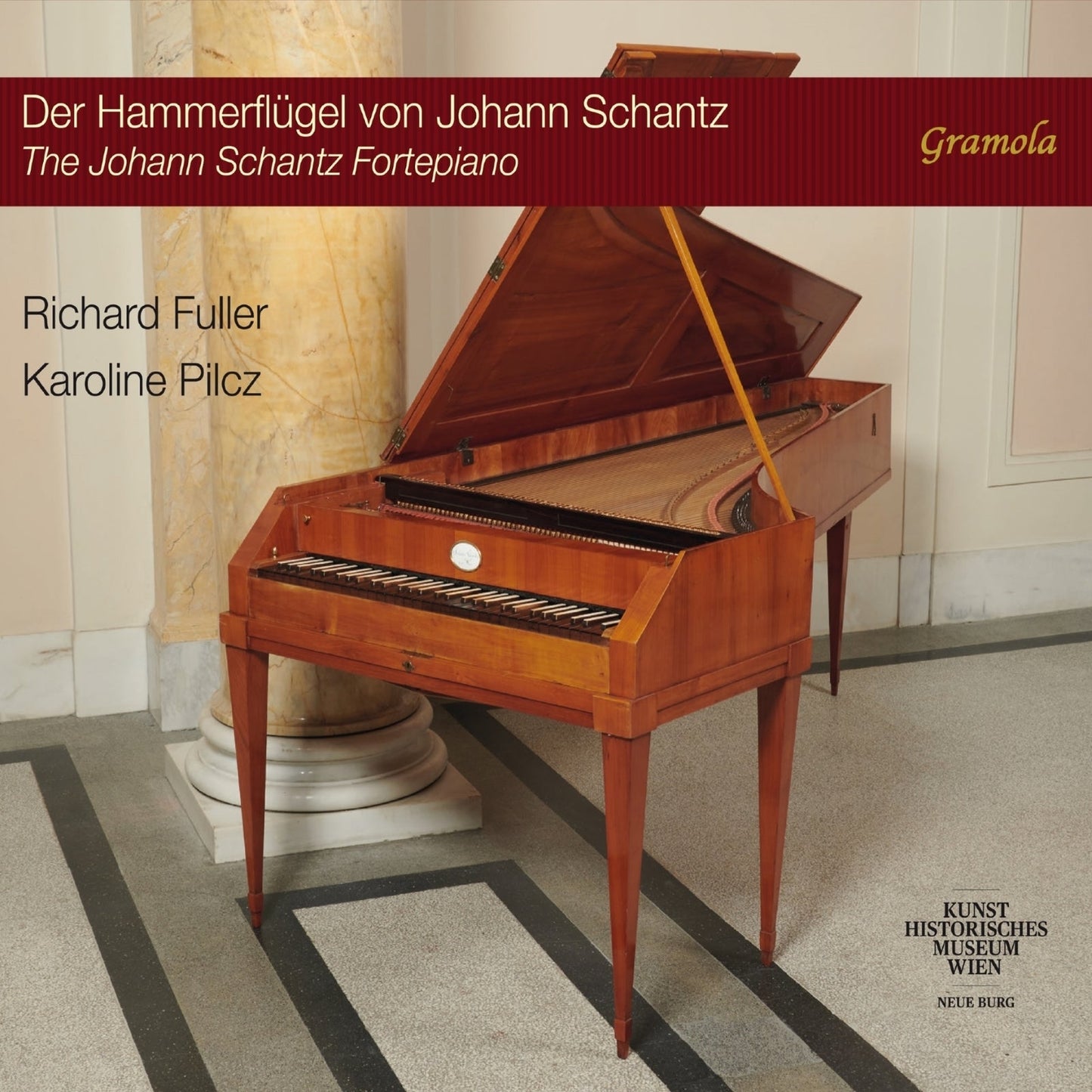 Wooden fortepiano with open lid, centered in a room with marble flooring.