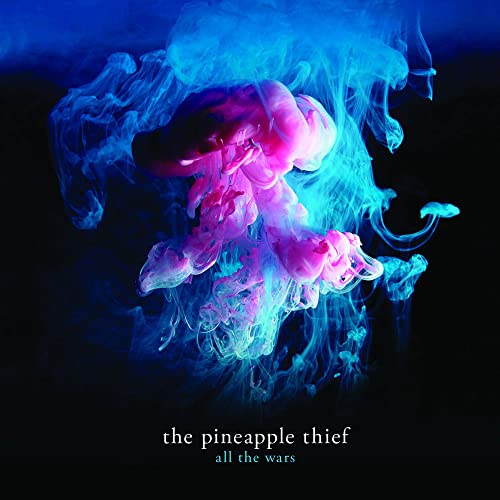 Pink and blue ink swirls in water against a black background with album text.