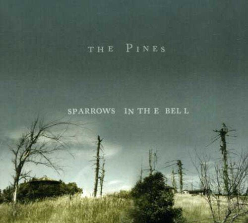 "Album cover with bare trees and grassy field, dark sky, and white text."