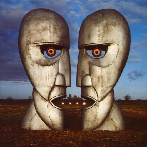 Two metallic heads facing each other with a distant landscape.