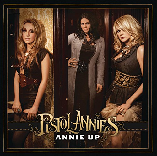 Three women, Pistol Annies, pose in front of an open doorway.