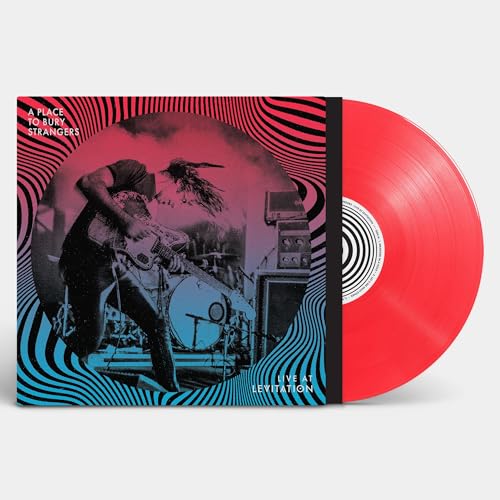 Red vinyl record with album cover featuring a guitarist and swirling design.