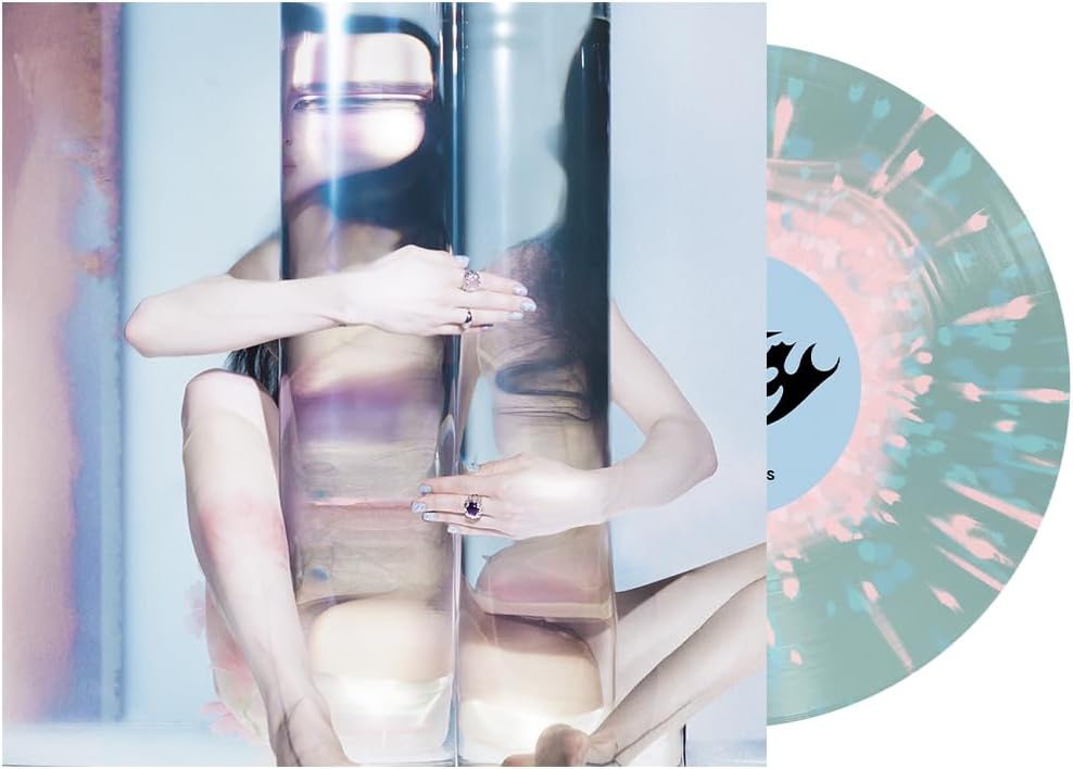 Vinyl record with pink and blue splatter, album cover featuring a person.