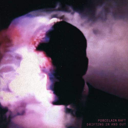 Silhouetted face against a blurred, colorful, smoky background.