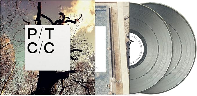 Vinyl record album cover with tree branches and two gray records.