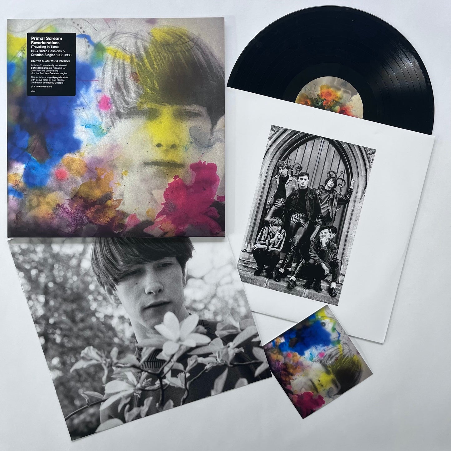 "Black vinyl record with album cover featuring a face surrounded by flowers."