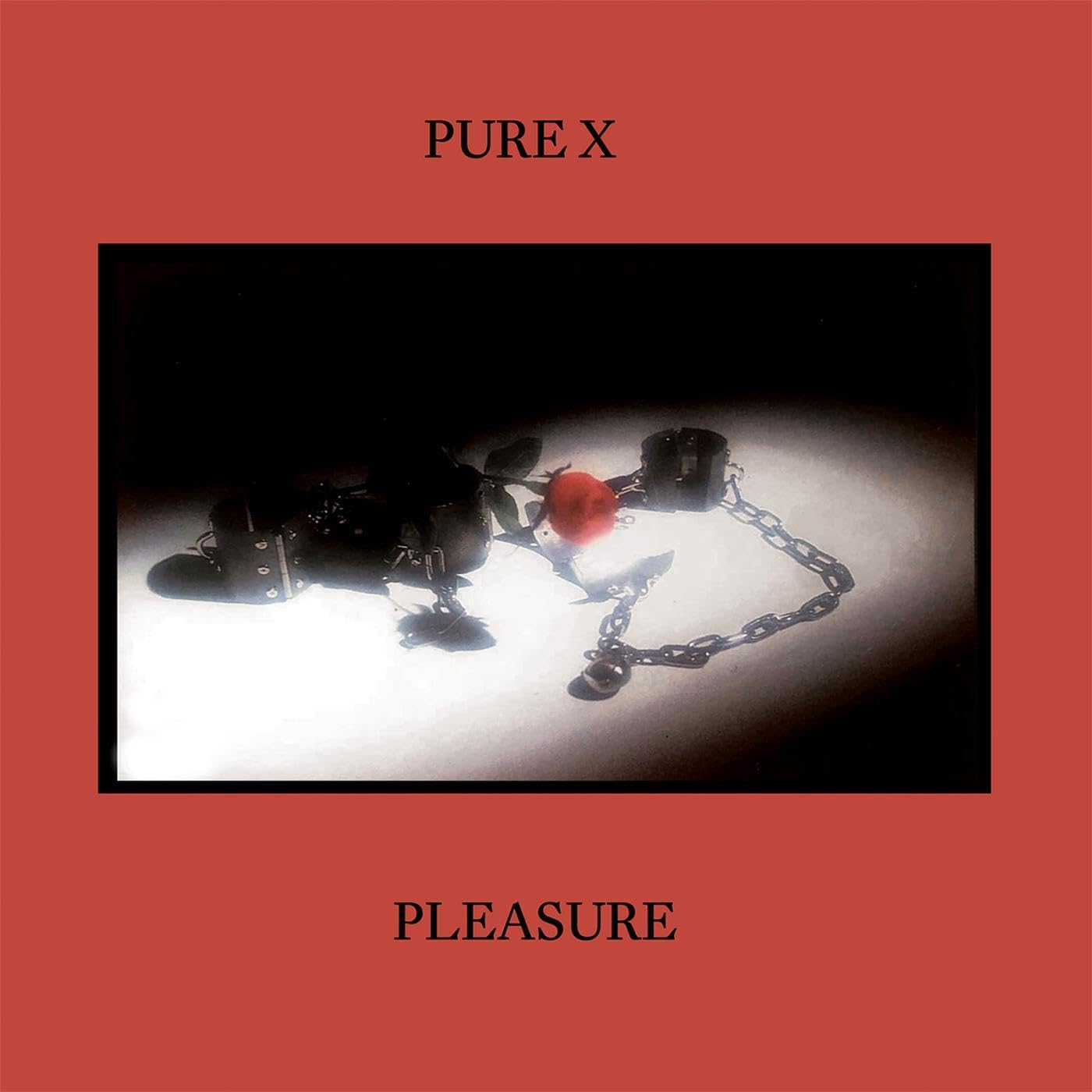 Album cover for Pure X’s “Pleasure” featuring chains and a red object.