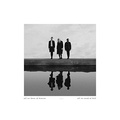Black and white album cover featuring three figures and their reflections.
