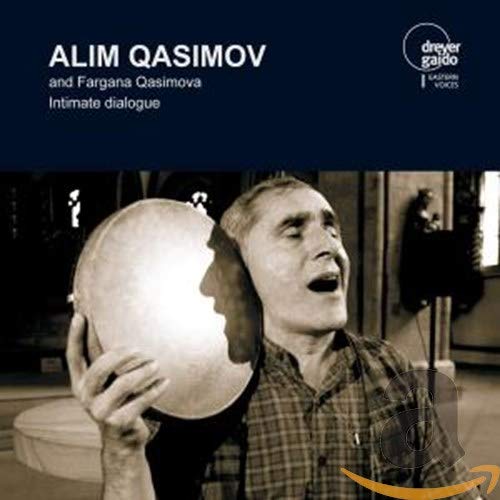 "CD cover with man holding reflective sphere, dark blue background, and white text."