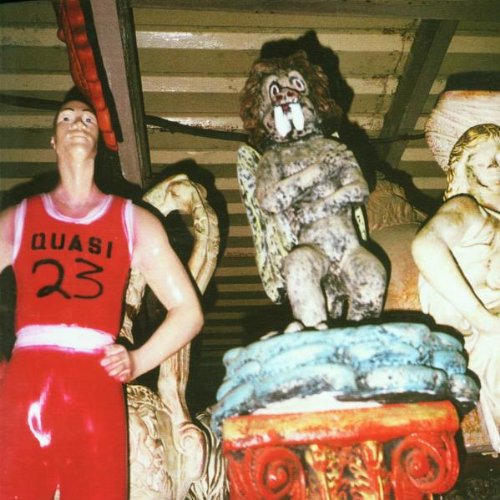 Man in basketball jersey and ape statue with angel wings.