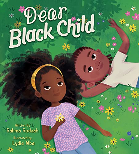Book cover with two Black children lying in a grassy field.