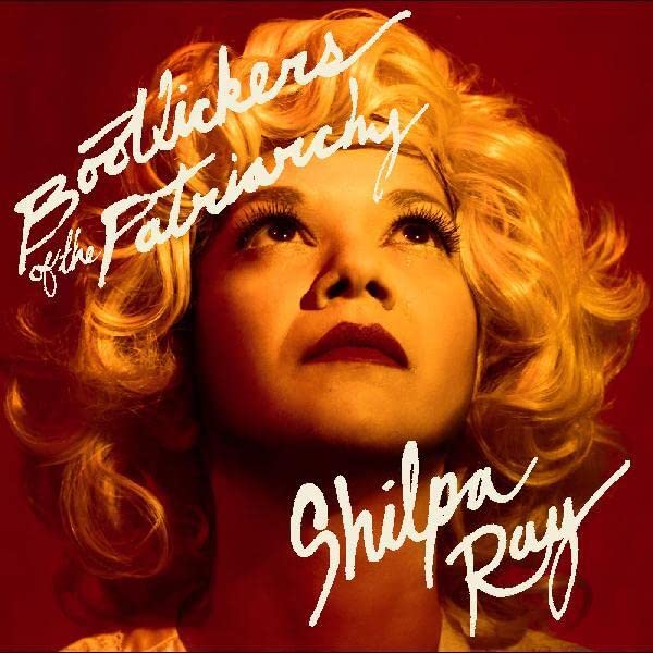 Vinyl album cover featuring a woman with blonde curly hair looking upwards.