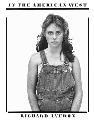 Black and white portrait of a young woman in denim overalls.