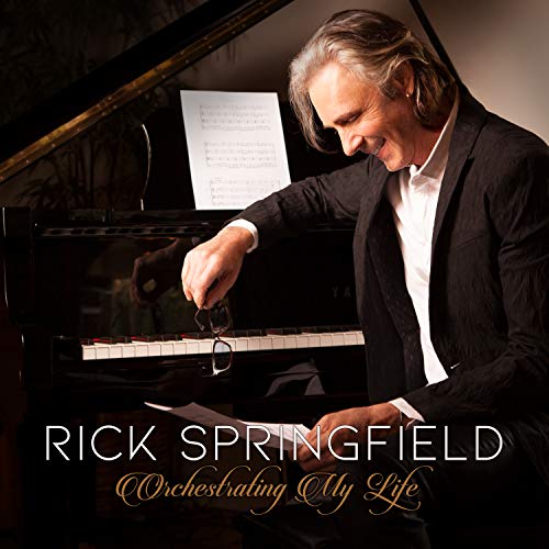 Rick Springfield at a grand piano, album cover for "Orchestrating My Life".