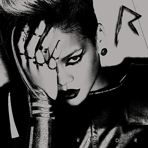 Black and white album cover featuring Rihanna with dramatic makeup and styling.