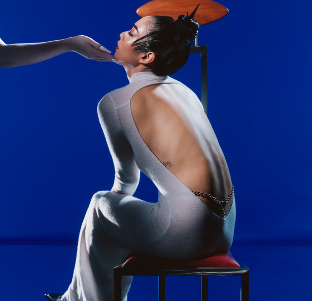 Rina Sawayama album cover, woman in white dress on blue background.