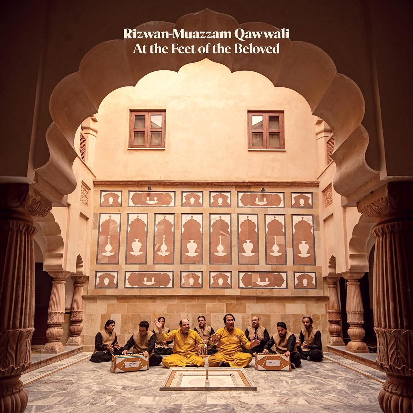 Qawwali musicians seated in an ornate archway, album cover art.