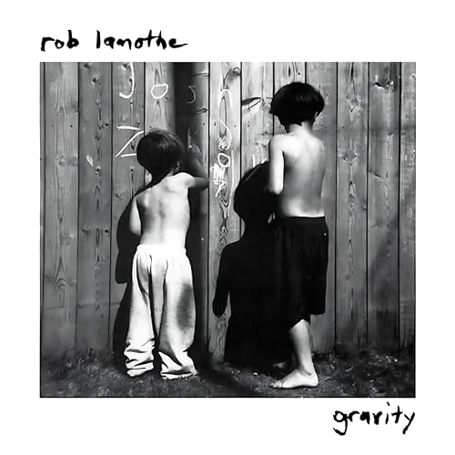 Black and white album cover featuring two young figures near a wooden fence.