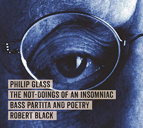 Close-up of an eye behind glasses, album cover for Philip Glass music.