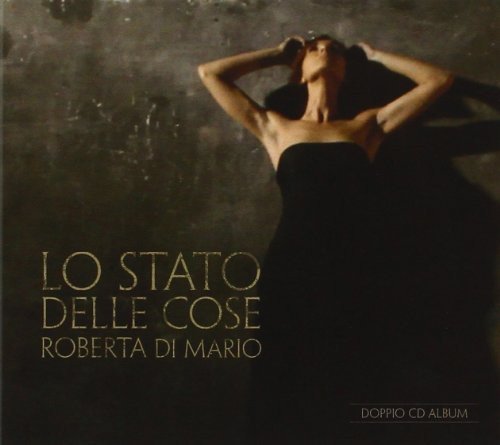 CD cover: woman in black dress with hands raised, dark background.